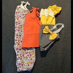 Lot of super cute baby girl clothes.